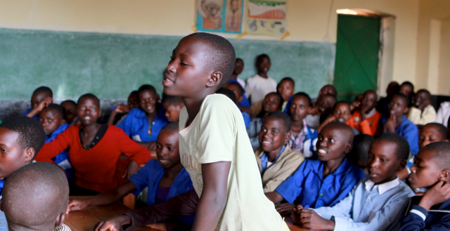 Girl asks question, Kabilizi School, Ngoma, Rwanda. Photo: Dining for Women/Flickr