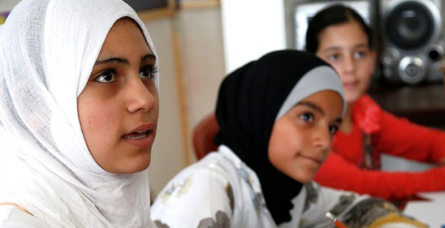 Teenage Syrian girls take part in a discussion about children's rights at a community centre in Lebanon. Photo: Russell Watkins/DfID