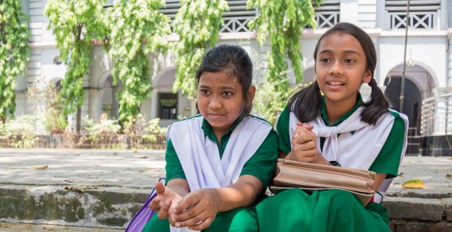 Two best friends sitting in the school yard, Chittagong, Bangladesh © Nathalie Bertrams/GAGE 2019